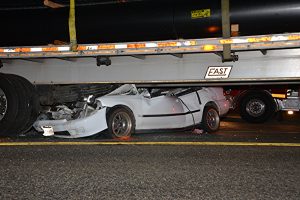 Car under big rig in Sunday night crash. photo by Rick McClure, for The Signal.