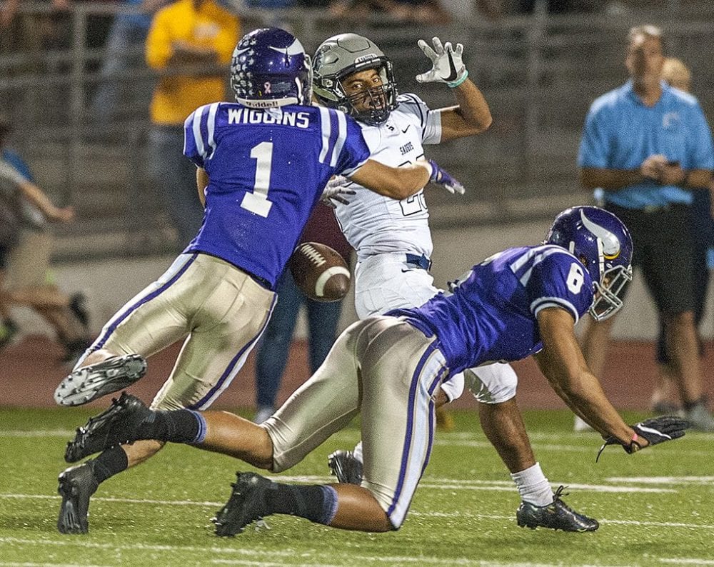 Valencia defenders Tim Wiggins (1) and Mykael Wright (8) break up a pass intended for Saugus receiver Amir Bishop (23). Photo by Tom Cruze for The Signal.