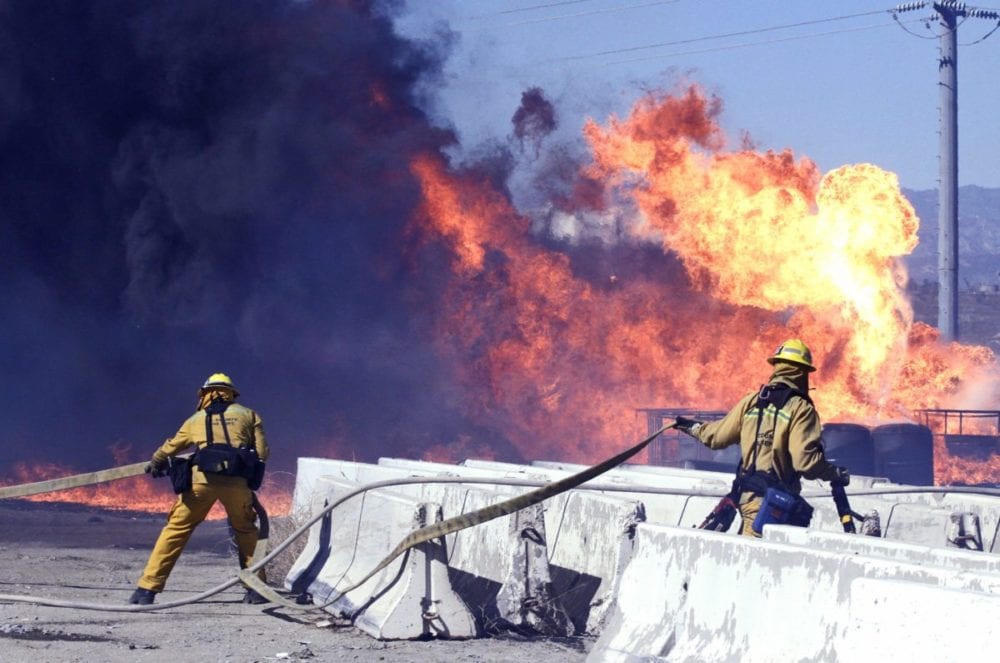 Los Angeles County fire fighters fight a fire that broke out near Sierra Highway and Via Princessa on Thursday. The fire burned through possible hazardous materials, according to officials on scene. Katharine Lotze/Signal