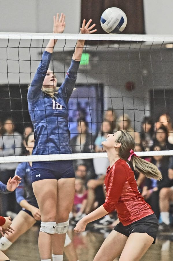 Trinity’s Allie Brown, left, taps a shot over the net against SCCS defender Kenzie Kennedy at SCCS on Tuesday. The Knights defeated the Cardinals in five games. Dan Watson/The Signal