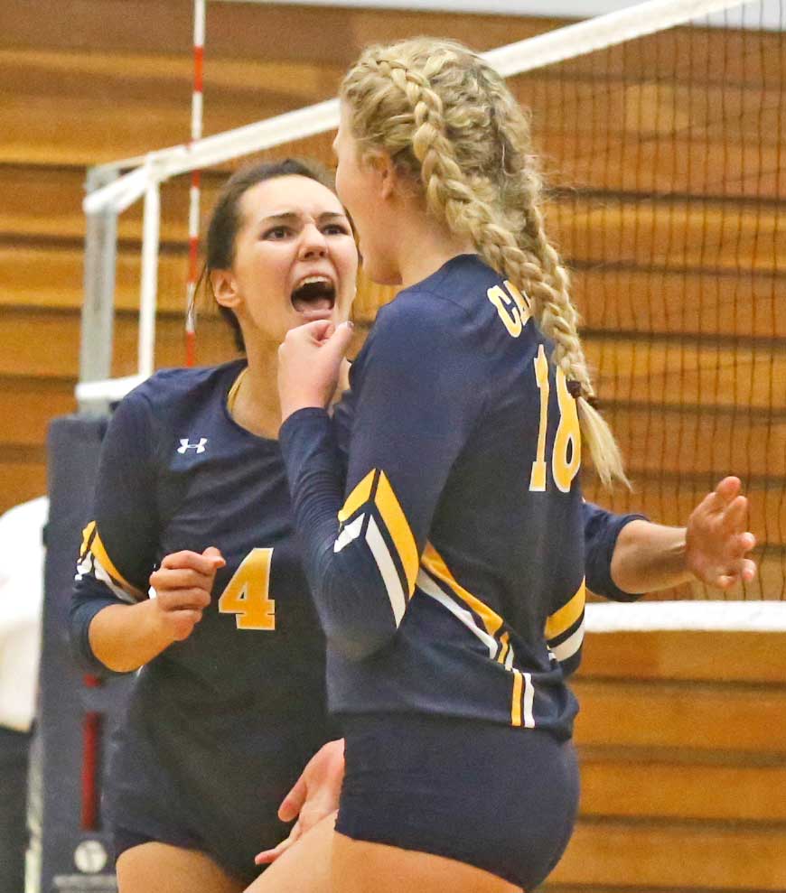 College of the Canyons’ Sam Nua, left, celebrates teammate Emily Burns’ successful block during a game against Pierce College at COC on Wednesday. Katharine Lotze/The Signal