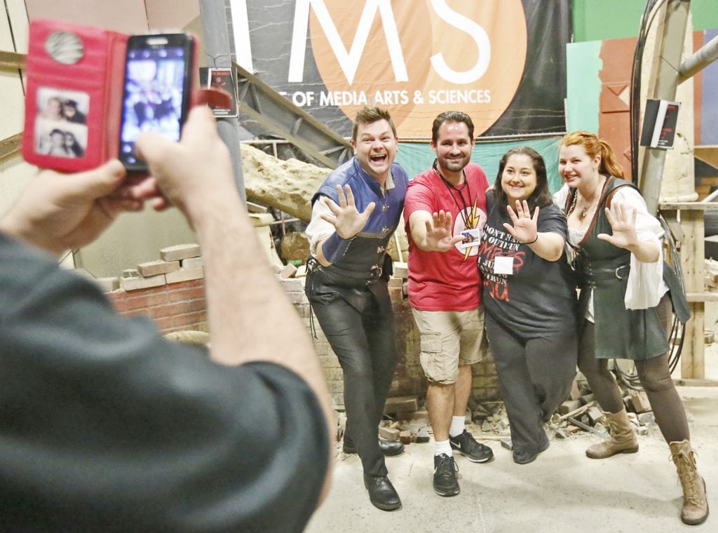 Left to right: Xander Jeanneret, Dustin Silva, Ambika Silva, and Bonnie Gordon take a photo together on the post-apocalyptic set at LIMS Motion Picture Studios in Castaic during the first day of the first-ever SCV Comic Con on Friday. Jeanneret and Gordon form the Library Bards, and performed at the first night of the convention. Katharine Lotze/Signal