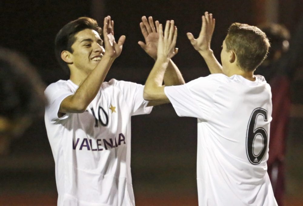 Valencia's Cesar Dominguez (10) and Tyler Traber (6) celebrate a goal during a non-conference match against Highland at Valencia High School on Wednesday. Katharine Lotze/Signal