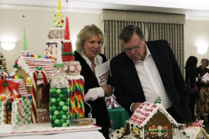 Kathy Kellar, left, and Santa Clarita Mayor Bob Kellar look at the gingerbread houses on display at the Magic of the Lights Gala event at the City of Santa Clarita Sports Complex on Saturday. Nikolas Samuels/The Signal