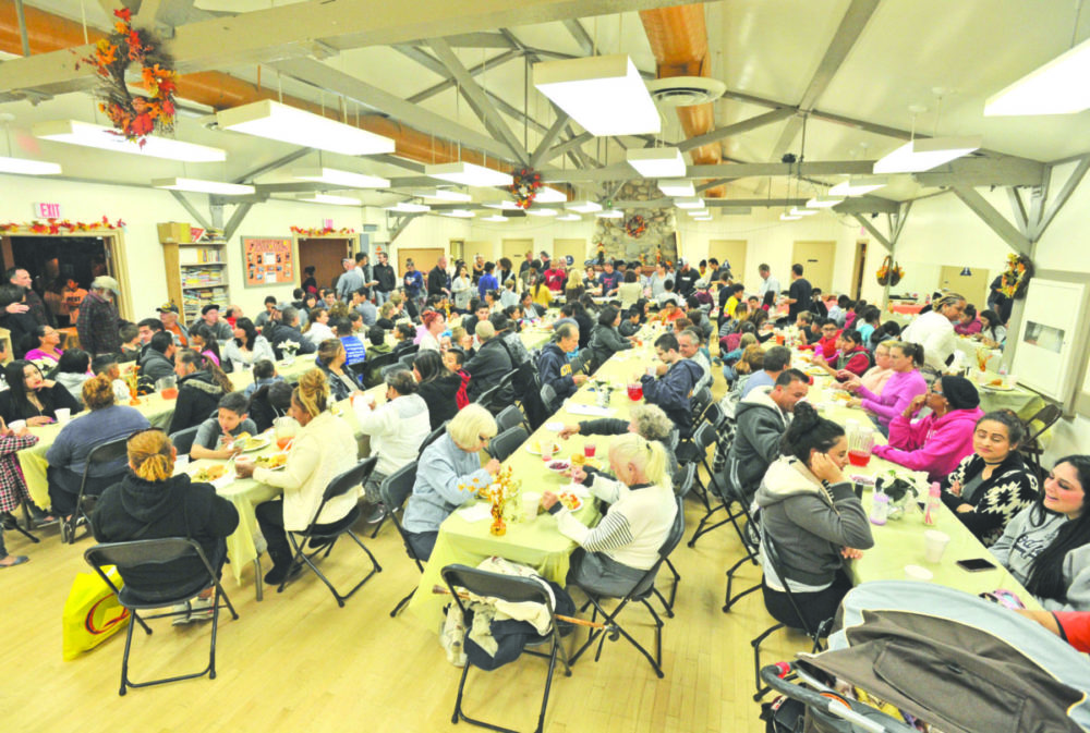 Real Life Church volunteers serve Thanksgiving dinner to members of the Val Verde community at the Val Verde Recreation Center.  Dan Watson/The Signal