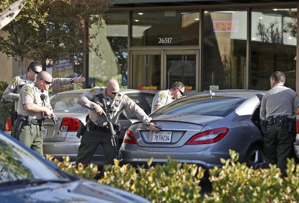 Sheriff's deputies approach a vehicle in front of GameStop on Friday after three males were instructed to exit the vehicle and detained at gunpoint. Katharine Lotze/Signal