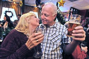 Carly and Bob Cookson of Newhall toast and kiss as they ring in the new year at the Rose and Crown British Restaurant in Newhall on Saturday. Dan Watson/The Signal