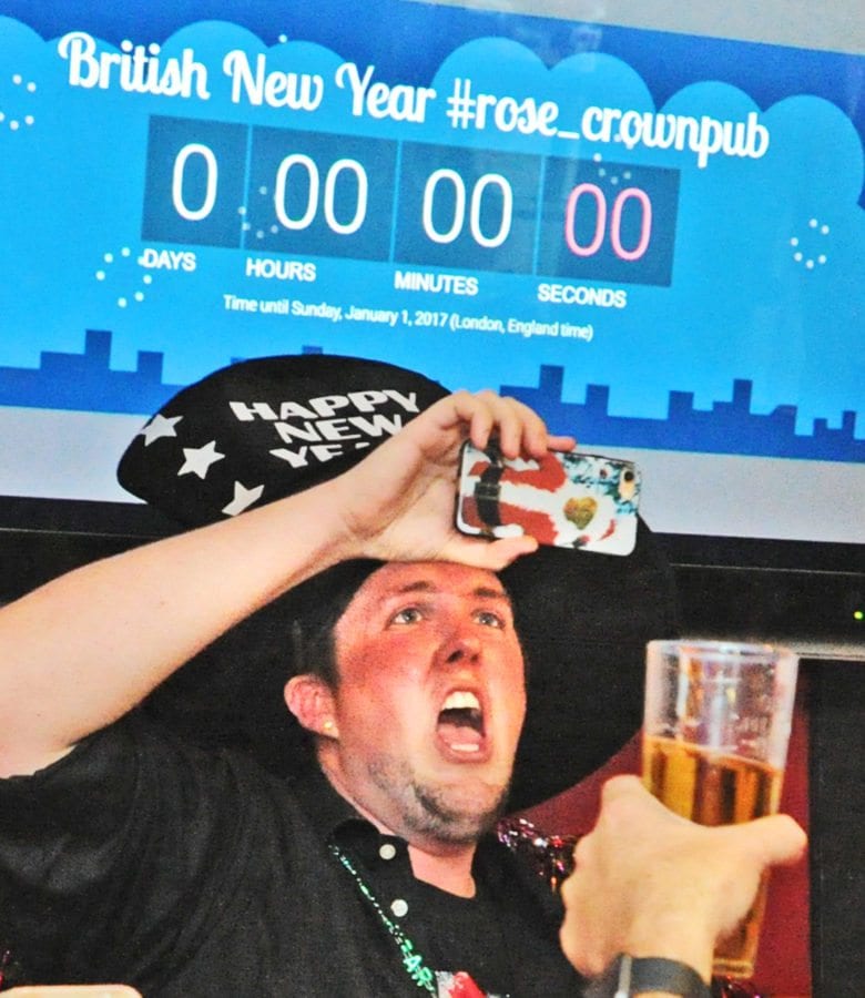 Greg Sutton, owner of the Rose and Crown British Restaurant takes a photo of the crowd as they count down to the new year, London England time - 4PM Santa Clarita time, at the Rose and Crown British Restaurant in Newhall on Saturday afternoon. Dan Watson/The Signal