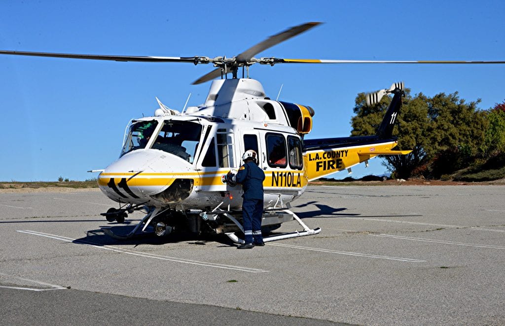 An infant who fell into a Stevenson Ranch pool is loaded into a fire department helicopter in an abandoned parking lot Wednesday. Rick McClure/For The Signal