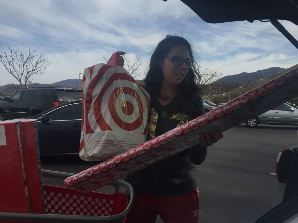 Elisa Yepes loads up discounted Christmas items into her vehicle on Monday. Samie Gebers/ Signal