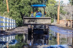  A man uses a skip loader to shift mud off Josel Drive near Iron Canyon Road in the Sand Canyon area of Santa Clarita Saturday afternoon. Austin Dave/Signal