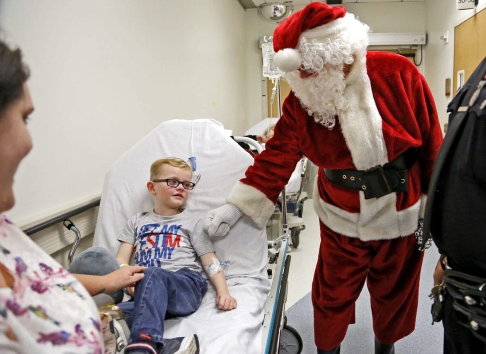 Santa gives an encouraging bump to James Powell, 5, during a visit to the Henry Mayo Emergency Department on Thursday. Santa and Zach's Miracle dropped by to deliver gifts to kids in the emergency room. Katharine Lotze/Signal