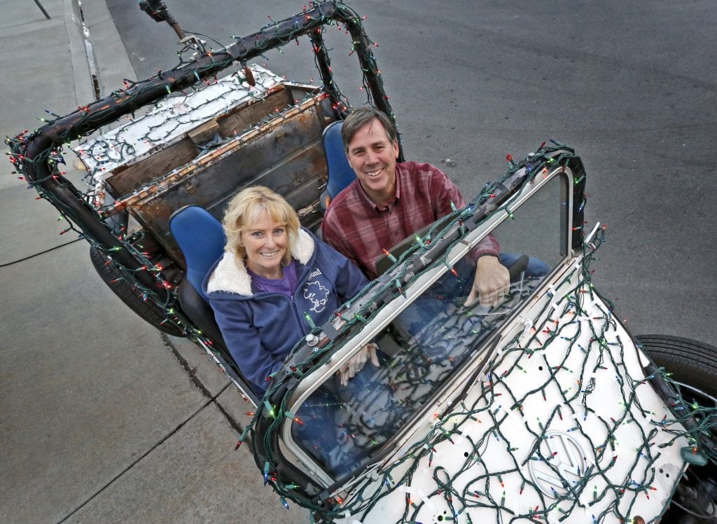 Keith and Mary Williams with their lighted dune buggy outside their Valencia home. They've been duct-taping Christmas lights to the street-legal vehicle for about three years. Katharine Lotze/Signal