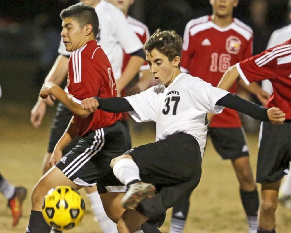 Albert Einstein Academy's Tyler Barton (37) kicks the ball toward the goal during a soccer match against Santa Clarita Christian at Central Park on Tuesday. Katharine Lotze/Signal