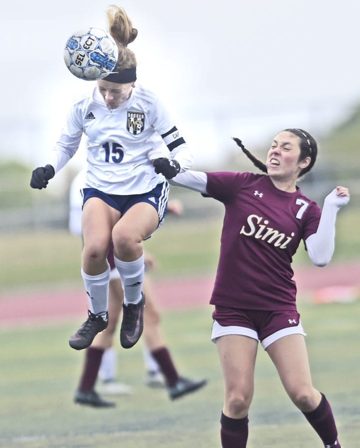 West Ranch's Rheana Patterson (15) heads a pass away from Simi Valley High School defender Amanda Crawford (7) at West Ranch on Wednesday.  Dan Watson/The Signal