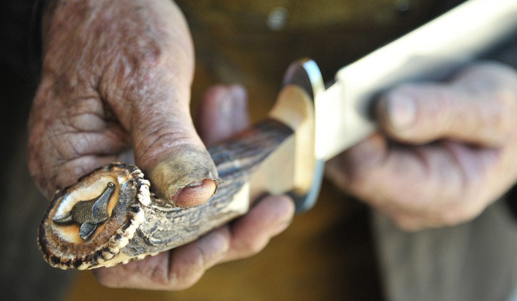 A fox head decoration is displayed on the Indian stage handle of the custom bowie knife. Dan Watson