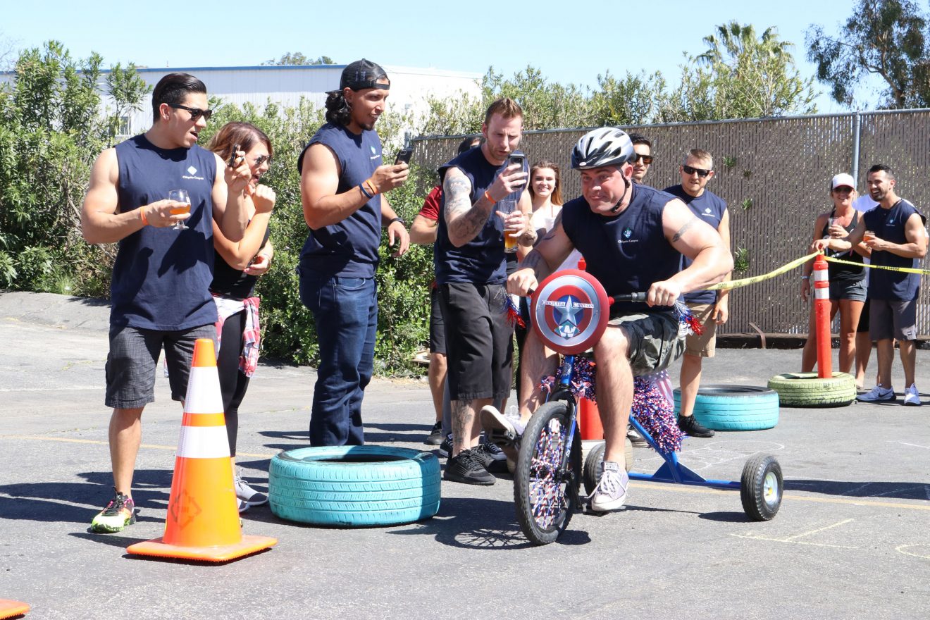 Adults race tricycles in the name of charity