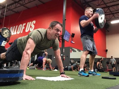 Brett Ivey, left, and Mike Miller, right, participate in Afterburn Fitness' Workout of the Day in support of the Sebastian Velona Foundation on Saturday.