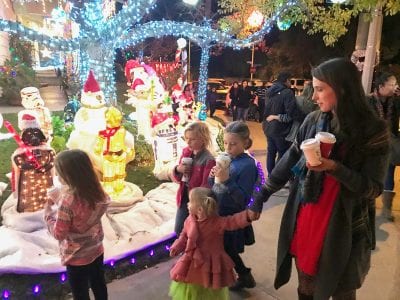 A family joins the parade of thousands who walked through Wakefield Court in Saugus on Sunday. The display is located off Copperhill Drive and Courtland Way in Saugus.