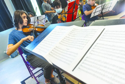 Leo Perez, a violinist with the Santa Clarita Valley Youth Orchestra, rehearses a song during their “Sounds of Summer” music practice session at the Youth Center of Christ Lutheran Church in Valencia, Calif., on Friday, July 8, 2022.