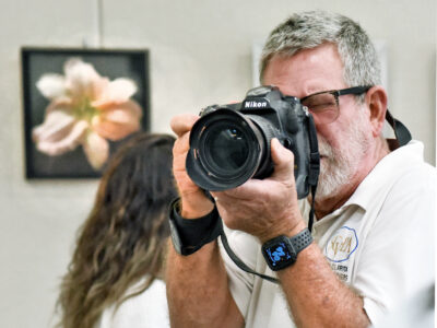 Santa Clarita Valley Photographers Association President Kevin Karzin photographs attendees during a reception and photos display held at the Old Town Newhall Library in Newhall on Friday, 072922. Dan Watson/The Signal