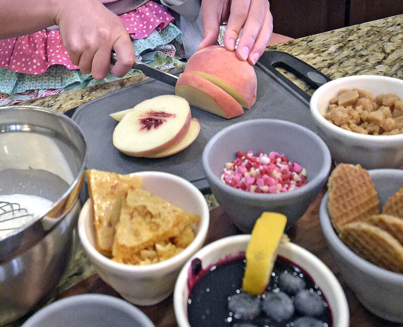 Kaya Novack, 13, cuts fresh fruit for Kaya's Creamery at her home in Saugus, 081722.  