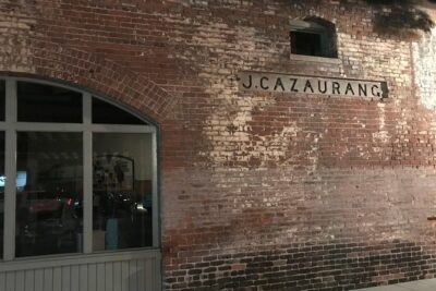 J. Cazaurang is the name of the first owner of this historic 120-year-old building in Pasadena featured on the Pasadena Ghost Walk. The two-story brick building began life as a hay and grain warehouse.