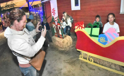 Tiffany Dumas takes a photo of her family during the Los Angeles County Department of Parks and Recreation Barnyard Lights Your at William S. Hart Regional Park on Saturday, 121821.