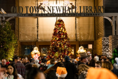 Event attendees gather around the Christmas tree for the ceremonial tree lighting during Light Up Main Street in Old Town Newhall on Saturday, Nov. 19, 2022.