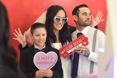 Logan Janes, 11, joins newly weds Stacey Moser and Andrew Janes for a photo during The Big I Do event held at The Center in Santa Clarita on Tuesday, 021423.