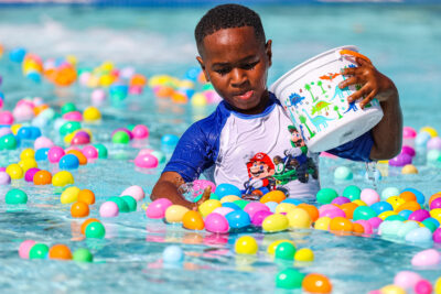 Johnny Tzanetatos, 6, puts Easter eggs in his basket for the Splash n' Dash Egg Hunt at the play area inside the Santa Clarita Aquatics Center in Santa Clarita, Calif., on Saturday, April 8, 2023.