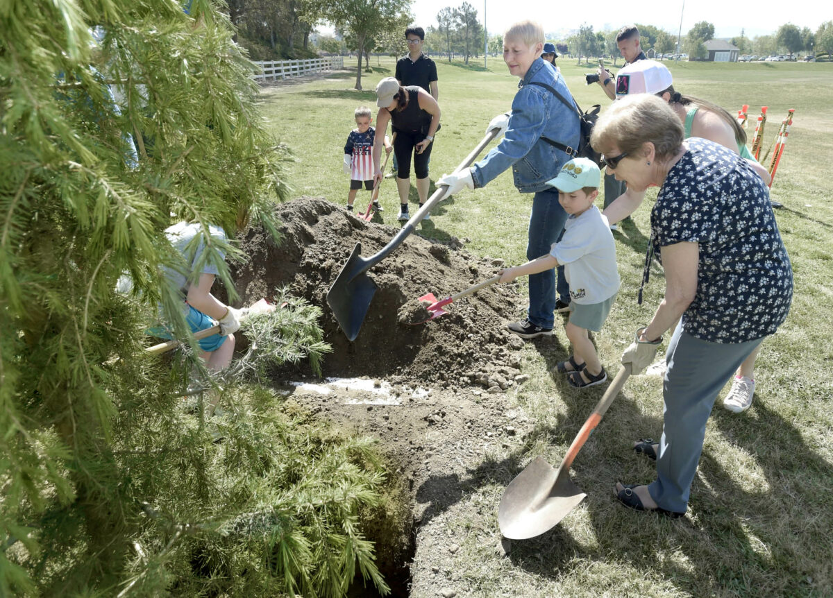 Children join Santa Clarita City Councilmembers Laurene Weste, center, and Marsha McLean as they help plant a Deodar Cedar tree for Earth Arbor Day during the Neighborhood Cleanup Drive-Thru event held at Bridgeport Park in Santa Clarita on Saturday, 042923.
