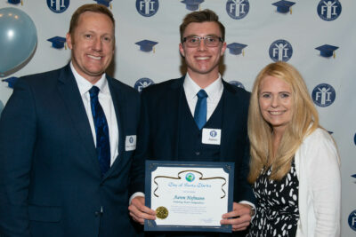 Mayor Jason Gibbs and Gina Stevens, program director for Fostering Youth Independence, congratulate Aaron Hofmann for receiving his bachelor's degree in engineering. Courtesy photo.