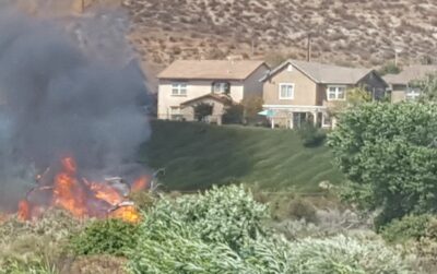 The fire Saturday afternoon was burning vegetation near homes and the intersection of Bouquet Canyon Road and Newhall Ranch Road. Dan Watson/The Signal