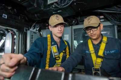 Electronics Technician 2nd Class Christopher Stansberry (left), a native of Elizabeth Lake, performs preventative maintenance on the SPS-73 navigation radar system with Electronics Technician 2nd Class Javier Varela, a native of Long Beach, in the bridge of USS Boxer (LHD 4), Aug. 21, 2023. Boxer is a Wasp-class amphibious assault ship currently underway in the U.S. 3rd Fleet area of operations. U.S. Navy photo by Mass Communication Specialist 2nd Class Connor Burns.