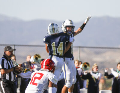 Zach Wyre (8) and Sands Alvarez (14) celebrate the first touchdown of the game during the first quarter of Friday's game against Pasadena at West Ranch High School. Habeba Mostafa/ The Signal