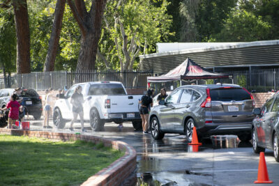 Cars waited in line to receive a car wash from the Hart show choir students Saturday morning, Sept. 9, 2023. Habeba Mostafa/ The Signal