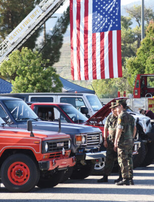Members of The Young Marines of Santa Clarita examine vintage 4X4 vehicles on display during the 3rd Annual Guardians 9/11 Patriotic Day Car Show and Breakfast held in The Higher Vision Church parking lot in Valencia on Saturday, 090923. Dan Watson/The Signal