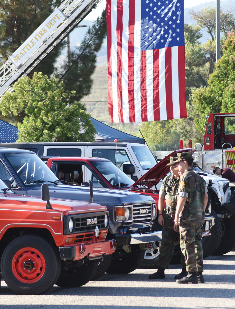 Members of The Young Marines of Santa Clarita examine vintage 4X4 vehicles on display during the 3rd Annual Guardians 9/11 Patriotic Day Car Show and Breakfast held in The Higher Vision Church parking lot in Valencia on Saturday, 090923. Dan Watson/The Signal