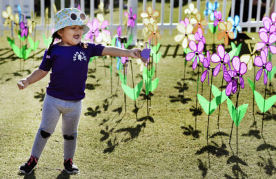 Stevie Ayuso, 2, points to flowers posted in the promise garden for her great-uncle and grandmother before the start the 2023 Walk to End Alzheimer's held at Bridgeport Park in Santa Clarita on Saturday, 100723. Dan Watson/The Signal