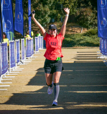 Nadya Nievera jumps in excitement after completing her first-ever marathon at the Santa Clarita Marathon presented by Elite Sports California at Heritage Park on Sunday morning. Katherine Quezada/ The Signal