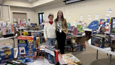 Nicki Buckstead, CEO of the Child & Family Center, and Cheryl Jones (wearing crown), the organization’s vice president of marketing and community outreach, expressed gratitude this month to ICE Recovery & Wellness, which collected new toys, jackets, warm clothes, bikes, blankets, diapers, hygiene products and over $3,000 in gift cards for clients of the center this holiday season. The donations covered the wish lists of over 70 local families, according to the nonprofit. Courtesy photo.