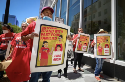 Jose Bautista marches with fast food workers and other SEIU members in support of a bill to create a state fast food industry council on May 31, 2022. Photo by Fred Greaves for CalMatters