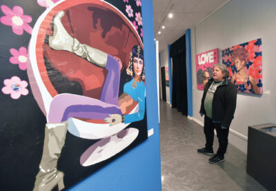 David Briton views the mixed media artwork on display as he attends the "15 Minutes of Fame" solo exhibit of artwork by Lynnda Rakos held at The Main in Newhall on Thursday, 122123. Dan Watson/The Signal