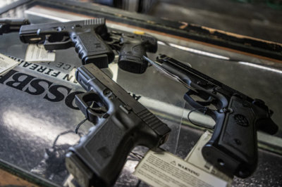 Handguns on a display case at a gun shop in Fresno County. Photo by Larry Valenzuela, CalMatters/CatchLight Local