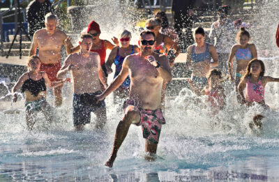 Lance O'Keefe leads a group into the 45 degree water during the Santa Clarita Polar Plunge held at the Santa Clarita Aquatic Center on Saturday, 010523. Dan Watson/The Signal