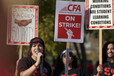 Jackie Barrett, a student and intern with California Faculty Association, speaks to the crowd during a faculty strike at CSU Pomona on Dec. 4. Photo by Lauren Justice for CalMatters