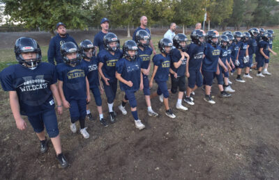 The Santa Clarita Wildcats team, ages eight, nine and ten year-olds prepares for practice at Central Park as they get ready for a playoff game. A new bill would see youth tackle football be banned for kids under 12. Dan Watson/The Signal