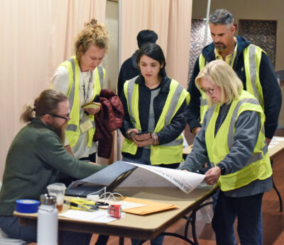 Bridge to Home clinical supervisor Tyson Pursley, seated, goes over the map of Santa Clarita with a group of volunteers from the Department of Mental Health as they prepare for the 2024 Homeless Count at the City of Santa Clarita Activities Center in Santa Clarita on Tuesday, 012324. Dan Watson/The Signal