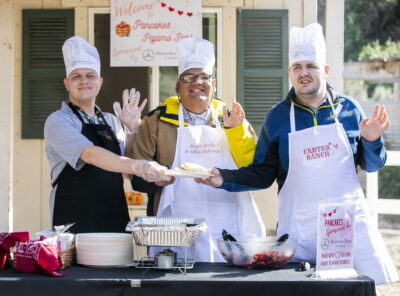 Nolan Anderle, left, Eduardo Lara, middle, and Aaron O'Dwyer, right, made pancakes from scratch at the Carousel Ranch Pancake and Pajama Party Saturday morning. Habeba Mostafa/ The Signal